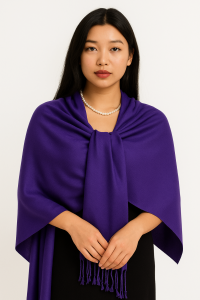 Woman wearing a deep purple pashmina shawl with tassels, styled with a pearl necklace.